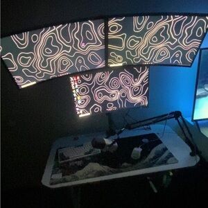 Triple Monitor Setup with Abstract Screensaver